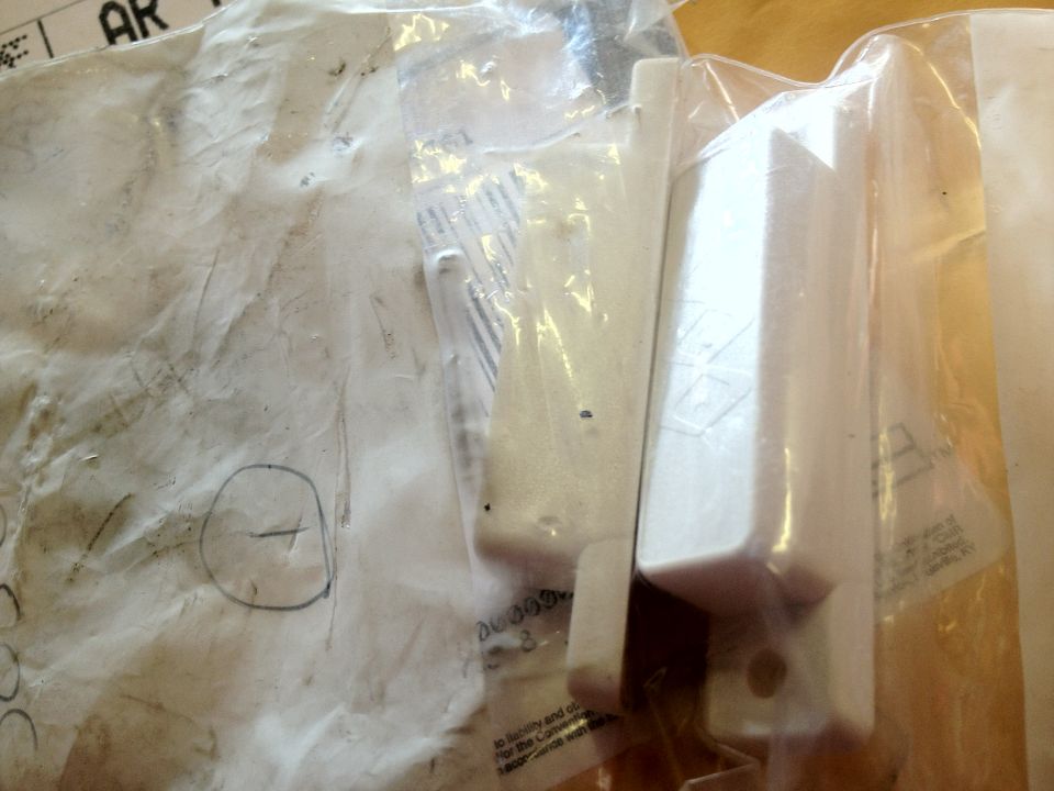 White plastic car parts in clear packaging