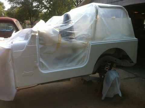 2000 Jeep TJ - A white Jeep TJ is being prepped for painting, with plastic sheeting covering most of the body.