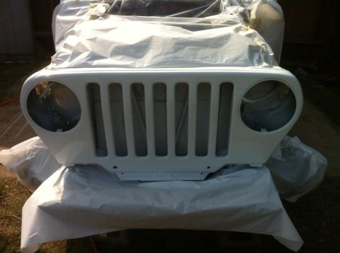 2000 Jeep TJ - Jeep TJ grille and fender assembly prepared for bodywork, likely painting.