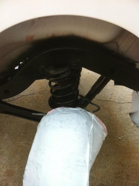 2000 Jeep TJ - Close-up view of a vehicle's suspension system, showing the coil spring and shock absorber.