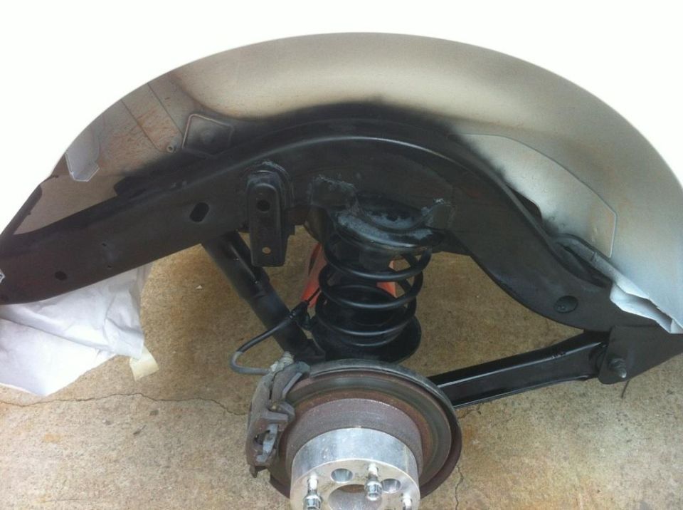 Jeep TJ suspension and fender well with coil spring and brake rotor
