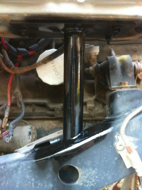 2000 Jeep TJ - Close-up view of engine bay components, including a black painted support and an oil filter.