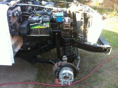 2000 Jeep TJ - Front suspension and engine bay of a 2000 Jeep TJ undergoing repairs, showing key components.