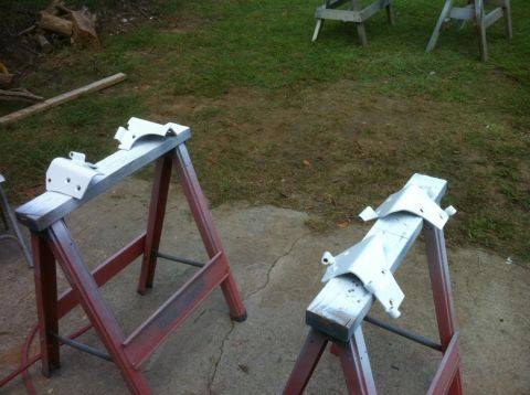 2000 Jeep TJ - Two white painted metal parts are drying on sawhorses in an outdoor setting.
