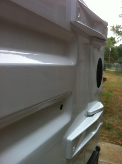 2000 Jeep TJ - Close-up of the rear corner of a white 2000 Jeep TJ, highlighting its distinctive bodywork and taillight housing.