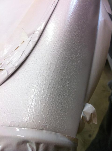 2000 Jeep TJ - Cracked paint texture on an interior car panel, possibly during a repair or restoration process.