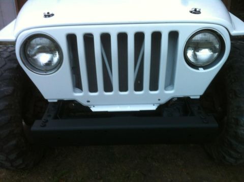 2000 Jeep TJ - Front view of a white 2000 Jeep TJ showing its iconic grille and headlights.