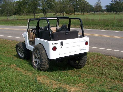 2000 Jeep Wrangler - This white Jeep features custom wheels and tires, with 'EARNHART' branding visible on the rear.