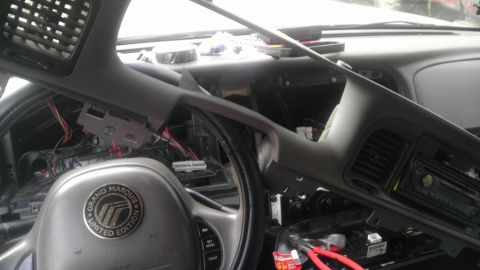 2000 Mercury Grand Marquis - The interior of a 2000 Mercury Grand Marquis is shown with the dashboard partially removed, exposing wiring and components.