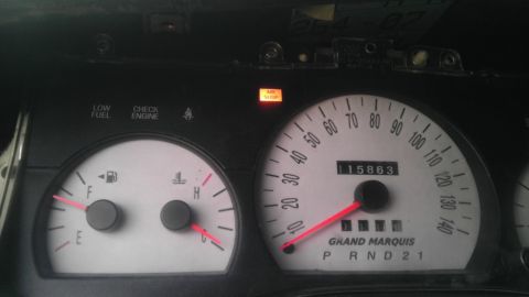 2000 Mercury Grand Marquis - The dashboard of a 2000 Mercury Grand Marquis displays mileage and warning lights.