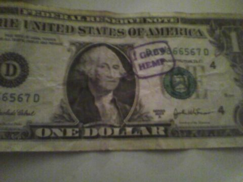 2003 Ford Crown Victoria - A one dollar bill is stamped with the words 'I GROW HEMP'.