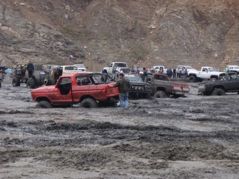 1978 Ford Bronco - A red 1978 Ford Bronco is stuck in the mud along with other off-road vehicles.