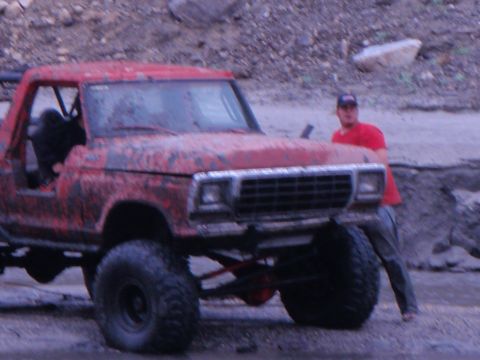 1978 Ford Bronco - A red 1978 Ford Bronco, modified for off-road use, is shown in a 3/4 front view.