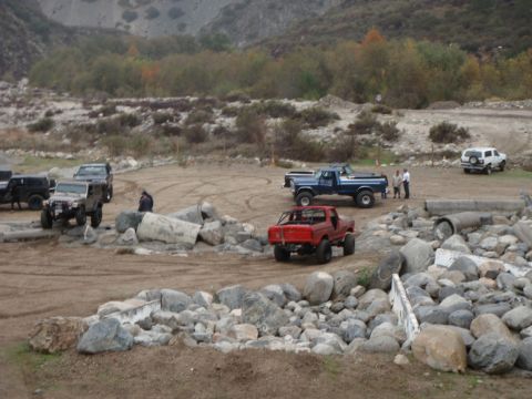 1978 Ford Bronco - Multiple off-road vehicles are gathered in a rocky, outdoor environment.