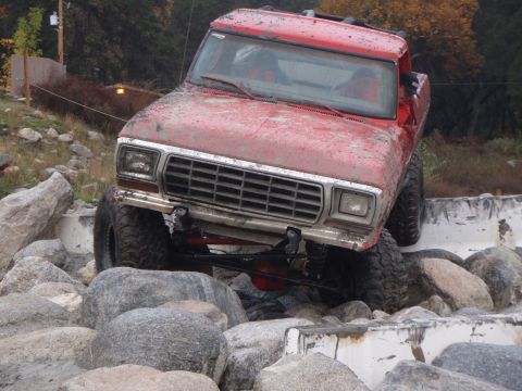 1978 Ford Bronco - This red 1978 Ford Bronco is shown off-roading over a rocky terrain.
