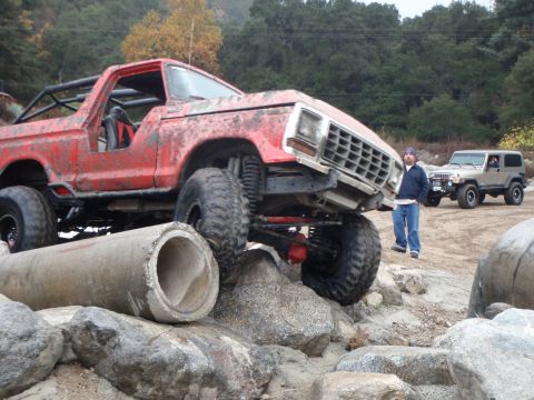 1978 Ford Bronco - Modified 1978 Ford Bronco navigating a rocky obstacle course with another vehicle in the background.