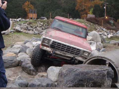 1978 Ford Bronco - This red off-road vehicle is attempting to traverse a rocky obstacle course.
