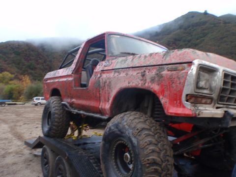 1978 Ford Bronco - This mud-covered 1978 Ford Bronco is loaded onto a trailer, ready for its next off-road adventure.
