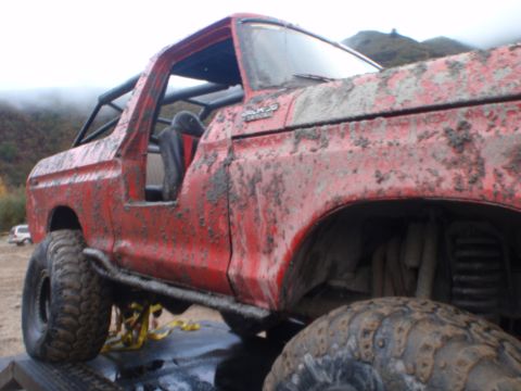 1978 Ford Bronco - This 1978 Ford Bronco is heavily covered in mud, suggesting recent off-road use.