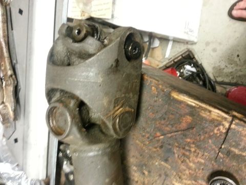 1978 Ford Bronco - A close-up view of a vehicle's driveshaft U-joint, likely undergoing maintenance or repair.