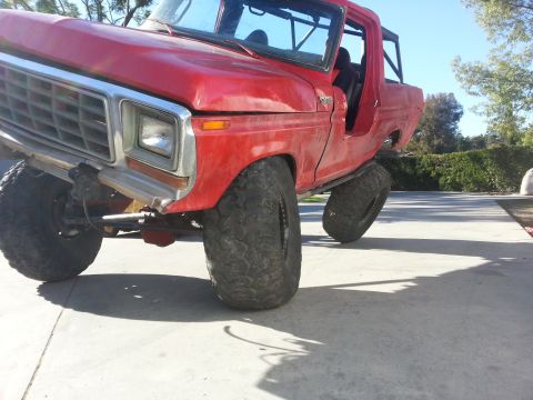 1978 Ford Bronco - This red SUV is modified with off-road tires and suspension, giving it a lifted appearance.