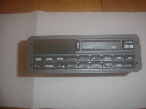 1996 Ford Bronco - This is a Ford car stereo unit, likely from the 1990s, a cassette deck and various control buttons.