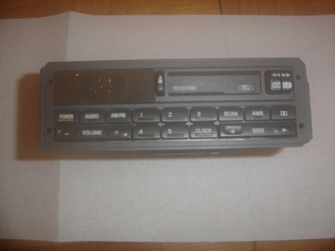 1996 Ford Bronco - Ford car stereo unit with CD player slot and numerous control buttons.