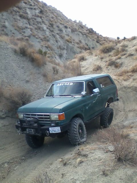 1991 Ford Bronco - This modified Ford Bronco navigates a steep, dry, and rocky incline, its off-road capabilities.