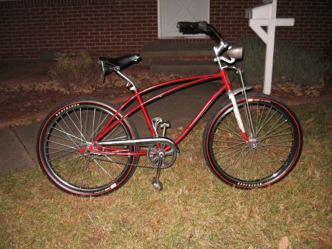 1994 Ford Bronco - A red cruiser bicycle with chrome details and black tires red sidewalls is parked on a grassy lawn.
