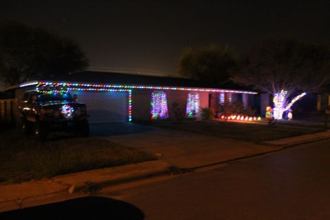 1990 Ford Bronco - A 1990 Ford Bronco is parked in a driveway, adorned with festive Christmas lights.