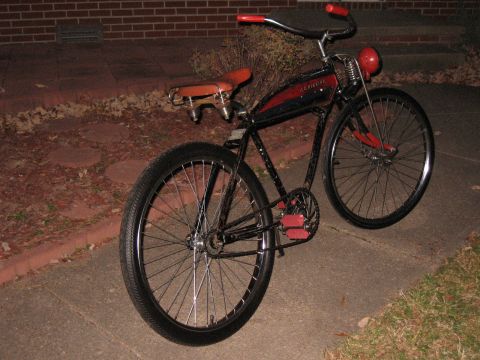 1994 Ford Bronco - A vintage bicycle with red accents is parked on a sidewalk at night.