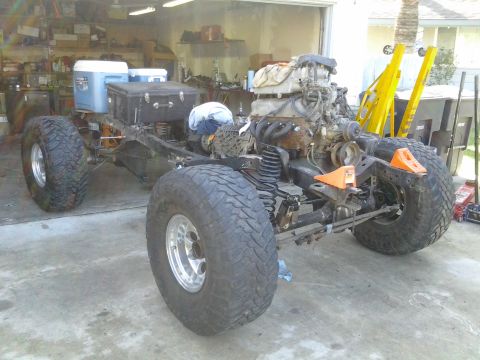 1968 Ford Bronco - This vehicle chassis is undergoing modifications, with an engine and large tires installed.