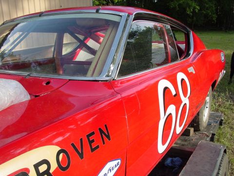 1968 Ford Torino - A red race car with the number 68 prominently displayed on its side is parked on a trailer.
