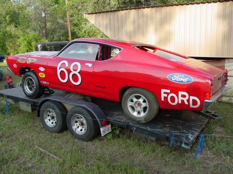 1968 Ford Torino - This red 1968 Ford Torino race car is loaded onto a trailer, ready for transport.