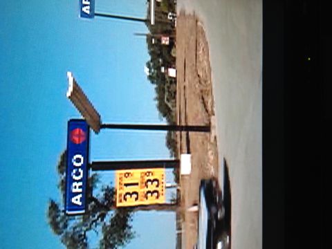 1999 BMW 5 Series - Gas prices at an ARCO station, with a car partially visible.