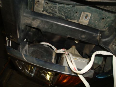 1995 Ford Bronco - Detail of a vehicle's headlight assembly, likely during repair or modification.