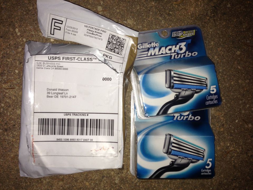 Two packages and two packs of Gillette Mach3 Turbo razor cartridges on a textured surface