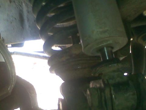 1994 Ford F-150 - Undercarriage view of suspension parts, a coil spring and shock absorber.