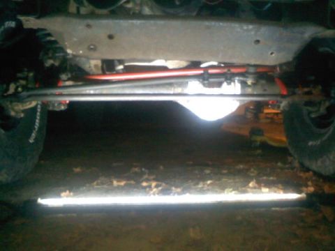 1994 Ford F-150 - The undercarriage of a truck reveals its suspension and differential, with BFGoodrich tires on the left and right.
