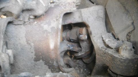 1994 Ford F-150 - A close-up view of a corroded suspension component, with a Supermotors.net watermark visible.