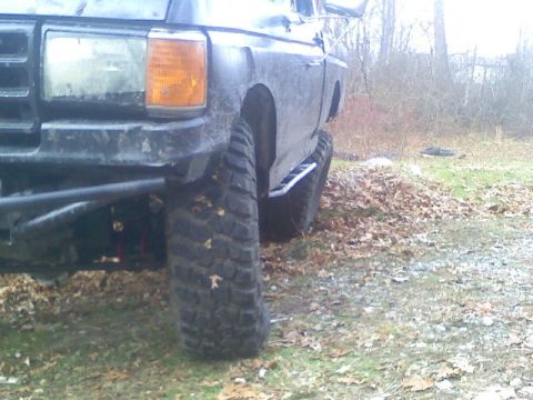 1994 Ford F-150 - This lifted 1992 Ford F-150 features large off-road tires and a custom step bar.