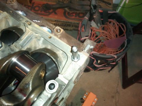 1990 Ford Bronco - A close-up view of an engine's internal components, including the crankshaft, in a workshop setting.