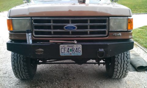 1987 Ford Bronco - Front view of a 1987 Ford Bronco, showing the grille, headlights, and custom bumper.