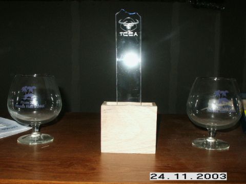 1998 Mercury Sable - A trophy stands between two glasses, one of which is engraved with 'Prom 2002 Nevada High School'.