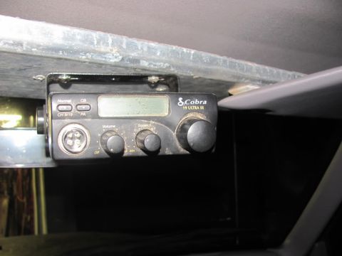 1994 Ford F-150 - A Cobra 19 Ultra III CB radio is mounted under a surface, likely in a vehicle's interior.