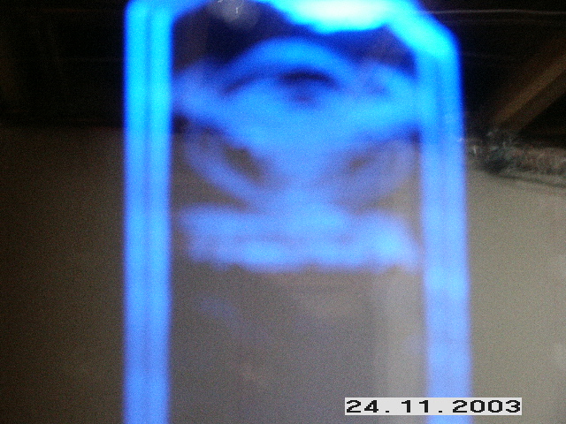 Blurred blue light illuminates an indistinct object, with "24. SUPERMOTORS.NET" visible at the bottom