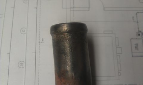 1991 Ford Festiva - A metal pipe is shown against a background of technical drawings and diagrams.
