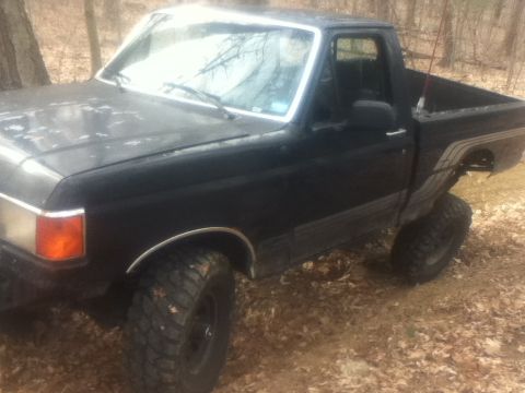 1994 Ford F-150 - This 1994 Ford F-150 pickup truck is shown in a 3/4 front view, lifted with large off-road tires.