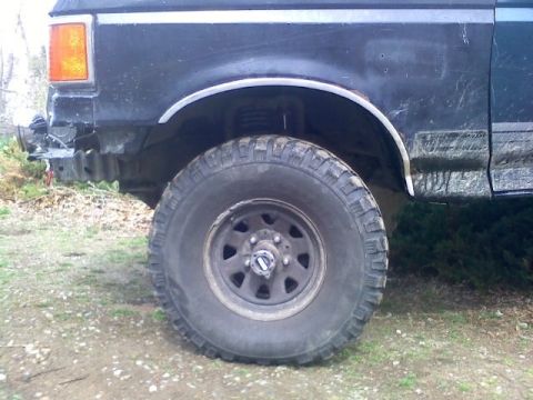 1994 Ford F-150 - Side view of a 1994 Ford F-150 showing the front fender and large tire.