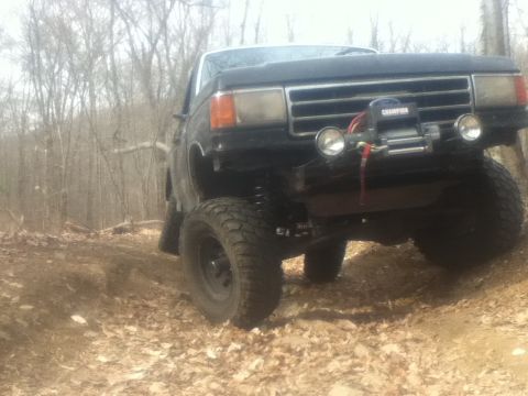 1994 Ford F-150 - This lifted pickup truck is equipped with a winch and auxiliary lights, ready for off-road adventures.